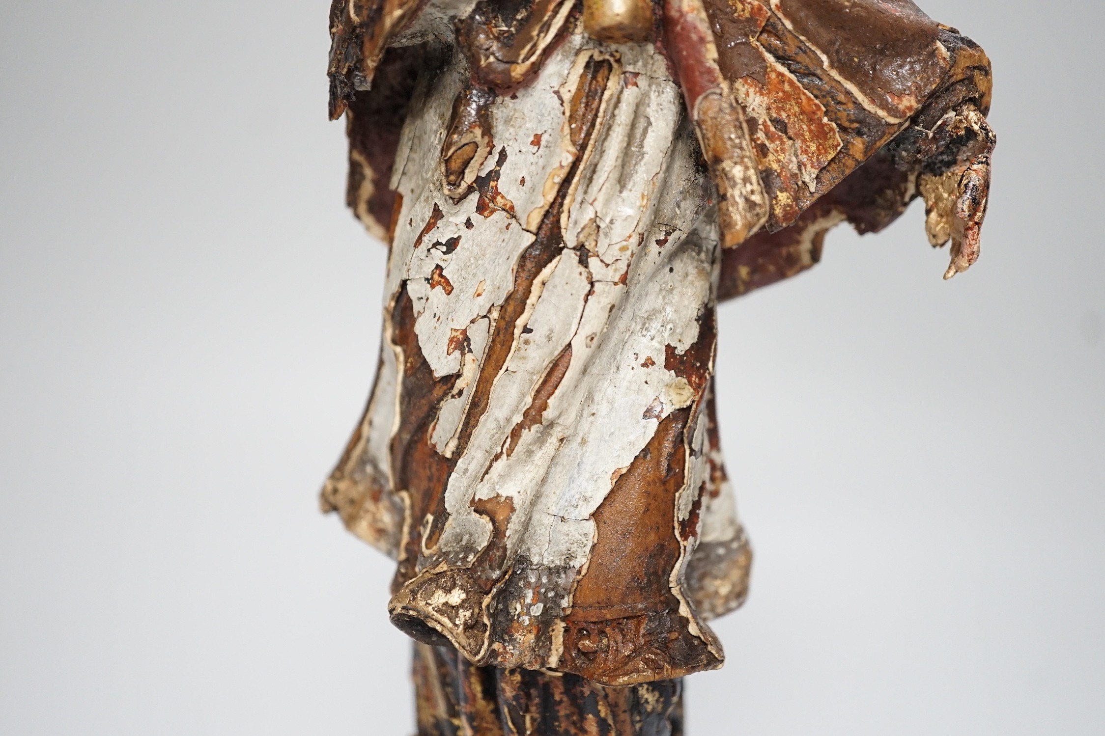 An 18th/19th century Continental carved wooden polychrome figure of saint, 33cms high